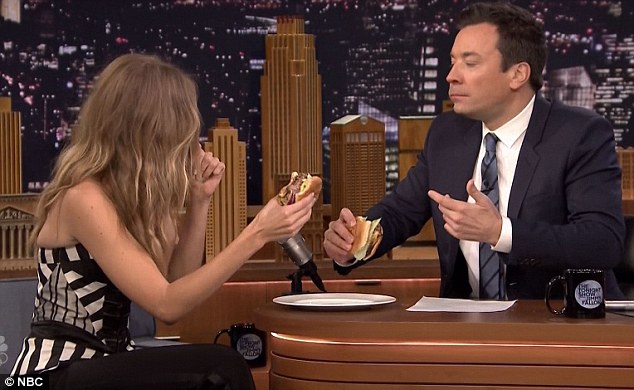 She approves: Once Gigi had checked for tomatoes, she was happy to indulge in a burger with the host