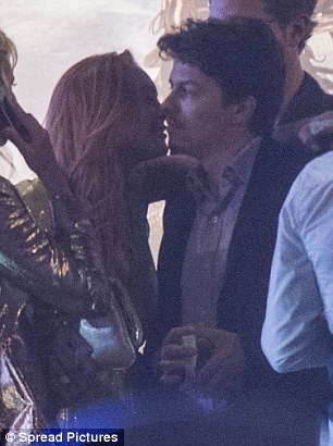 Loved-up: The 29-year-old actress was seen showering her Russian beau with kisses as they waited for a chauffeured car to take them home